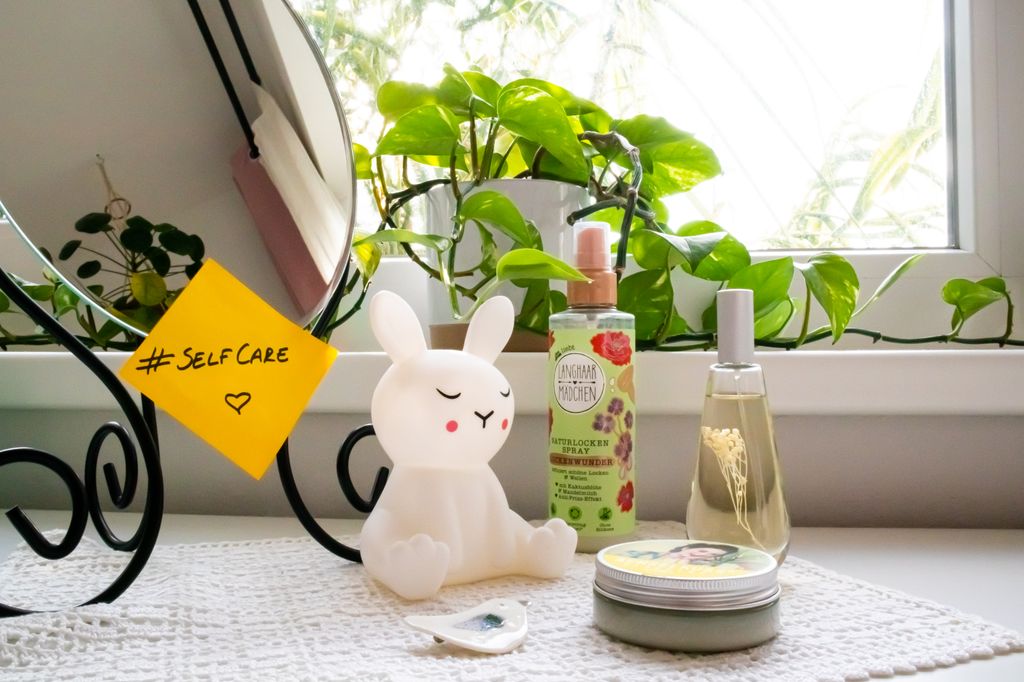 A reminder to prioritize self-care image containing bath products.